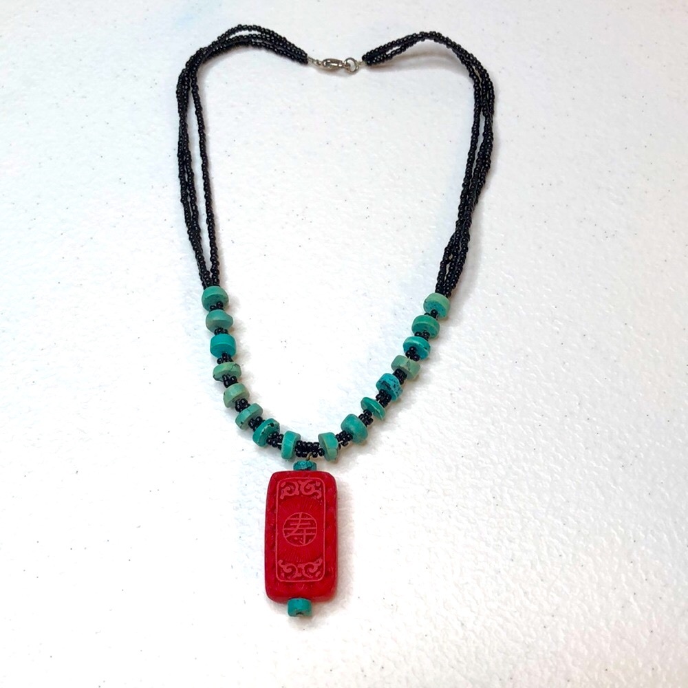 Necklace with turquise beads and red pendant with Chinese longevity symbol